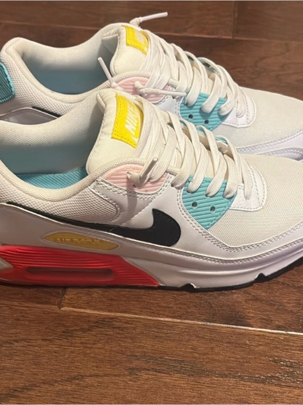 Nike White Sneakers with Black Swoosh and Pastel Accents